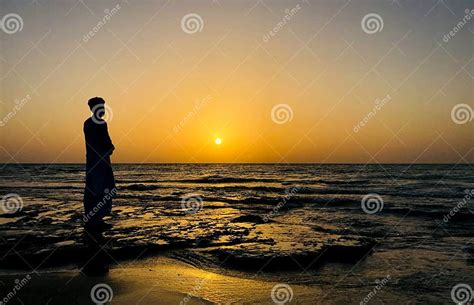 A Young Man Standing At Beach In Front Of Sunrise Sad Expression Sad