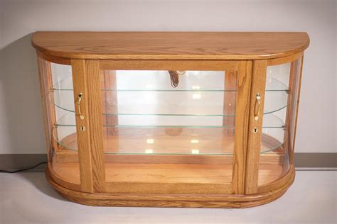 A glass mirrored back enhances the view. Large Curio Console Cabinet from DutchCrafters Amish Furniture