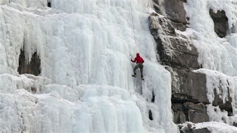 Man Ice Climbing Steep High Mountain Frozen Waterfall Ice In Utah