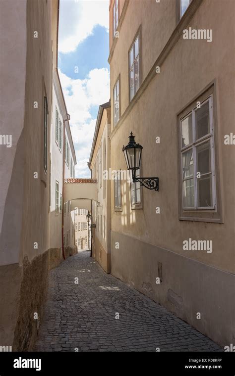 Narrow And Empty Cobblestone Thunovska Street And Old Buildings At The