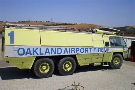 An Oakland Airport Fire Truck Parked In A Parking Lot