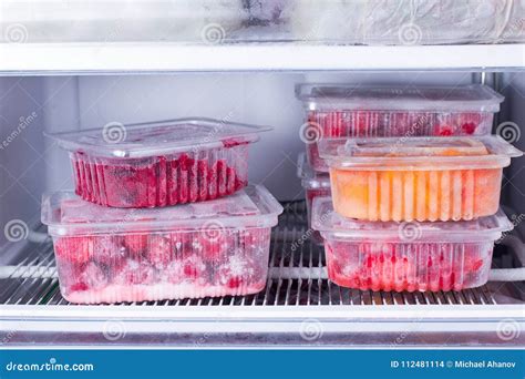 Frozen Fruits And Berries In A Container In The Freezer Stock Photo