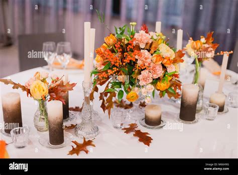 Wedding table that decorated with flower arrangements and candles Stock