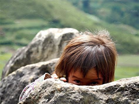 Girl hiding behind the rock, Vietnam ~ People Photos ~ Creative Market