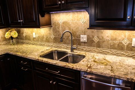 Contemporary kitchen with green island countertop. Mottled white granite countertop. From a recent ...