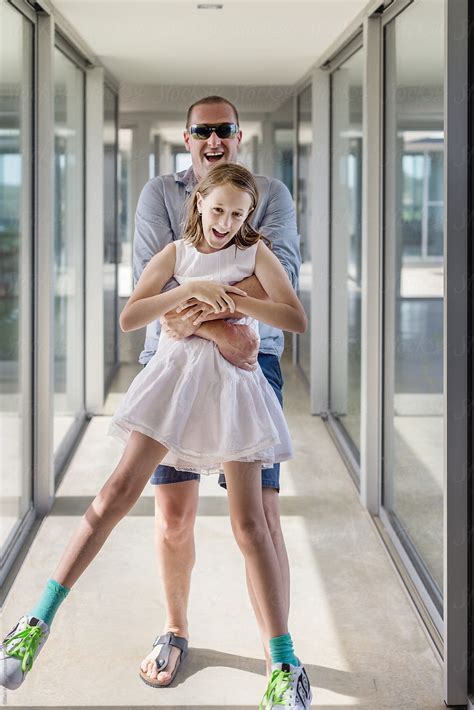 Father And Daughter Laughing In A Hallway Of A Modern Home By Stocksy Contributor Gillian