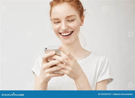 Cheerful Redhead Girl Smiling Looking At Phone Screen Stock Image Image Of Freckle Bright