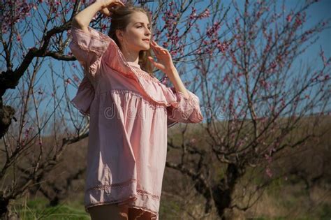 Beautiful Blonde Woman In Pink Dress Walks Through The Flowering Garden Stock Image Image Of