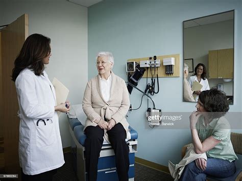 Mature Female Patient In Exam Room With Doctor High Res Stock Photo