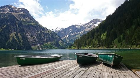 Royalty Free Photo Three Green Canoe Boats On Brown Wooden Dock Beside