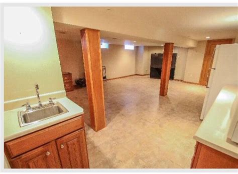 Dark brown wood ceiling beam with mood lighting, conceals plumbing and highlights the wood panel ceiling which adds texture and character to the space. Basement support beam idea | House, Support beam, Basement