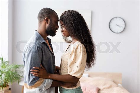 Side View Of African American Husband And Wife In Casual Clothes