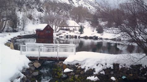 Aerial Winter Snow Mountain Cabin On Pond Stream 4k 281