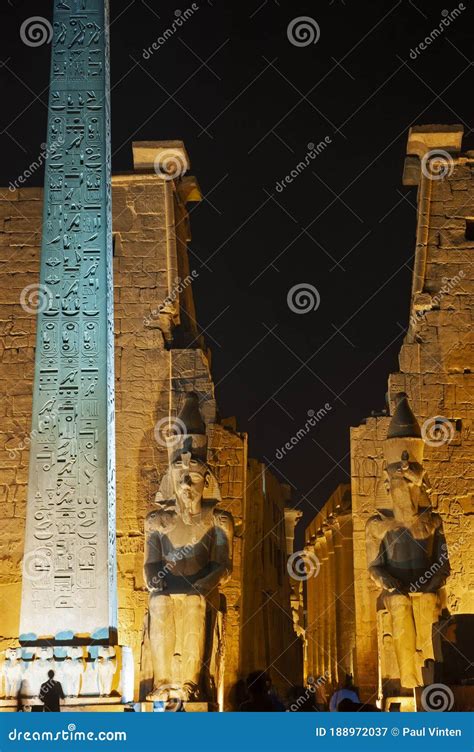 Statue And Obelisk At Entrance To Luxor Temple During Night Stock Image