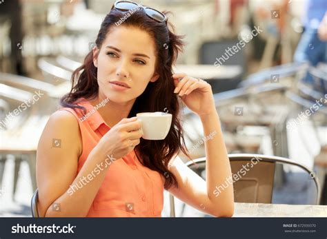 Young Woman Drinking Cappuccino Cafe Outside Stock Photo 672939370