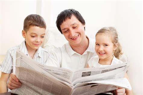 Dad With Daughter And Son Reading Newspaper Stock Images Image 33591194