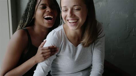 Emotional Portrait Of A Homosexual Mixed Race Couple Two Lesbian Women Laugh Smile And Hug