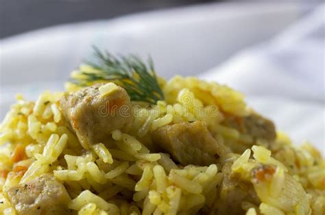 Macro Traditional Pilaf Rice With Meat Carrots And Onions On A White