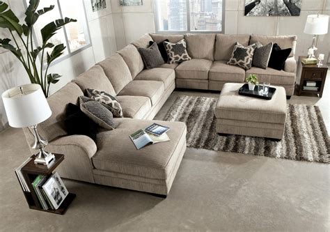 Soft Brown Fabric Long Sectional Sofa With Chaise In One Side Together With Decorative Cushion And Wooden End Table Plus Ottoman Coffee Table 