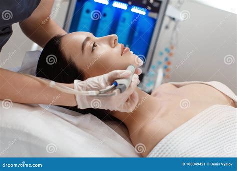 Professional Female Cosmetologist Doing Hydrafacial Procedure In