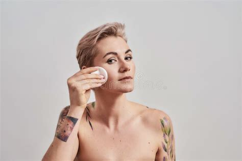 Clear It Up Portrait Of Beautiful Tattooed Woman With Pierced Nose And Short Hair Removing