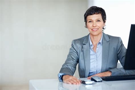 Smiling Female Executive At Office Desk Portrait Of Successful Female