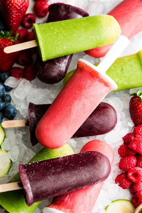 Several Popsicles With Fruit On Them Are Sitting On Some Ice And Watermelon
