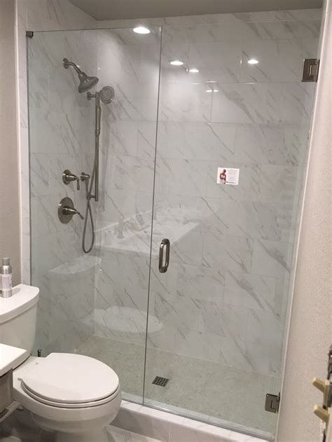 Frameless Inline Shower With Stationary Panel And Door That Swings In