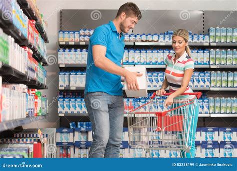 Smiling Couple Buying Dairy Products In Supermarket Stock Image Image Of Married Girlfriend