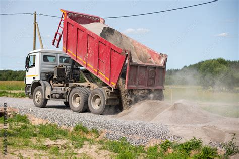 Dump Truck Is Unloading Soil Dumper Truck Is Unloading Soil Or Sand At