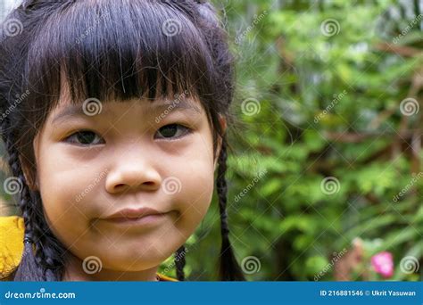 Portrait Close Up Headshot Of An Adorable Little Asian Girl Smile And