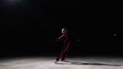 Professional Girl Skater Moves On Ice On Skates With Legs Unfolded To
