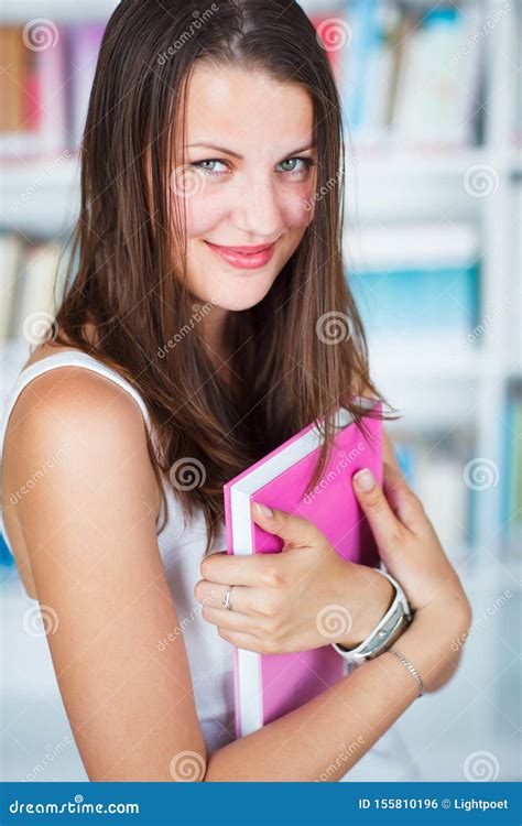 Pretty Female College Student Studying In The University Library Stock