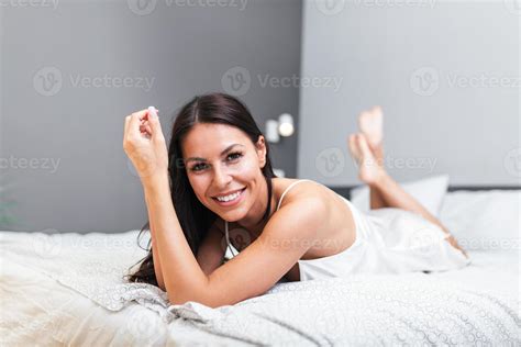 Cheerful Woman Lying On The Bed At Home Beautiful Smiling Woman With