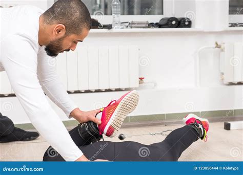 Personal Trainer Instructing Woman At Gym Stock Photo Image Of