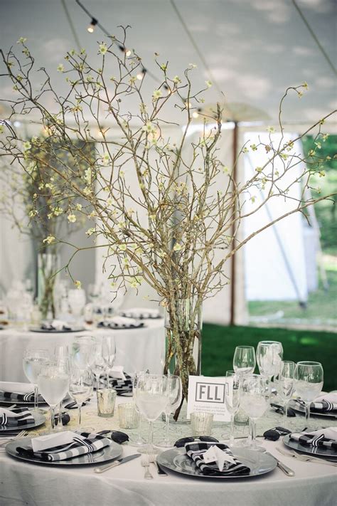 Olive branches never go out of style, and why would they, considering. Tall Centerpieces with Flowering Quince Branches
