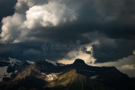 Storm Clouds Over Snowy Mountains In Banff National Park Stock Photo