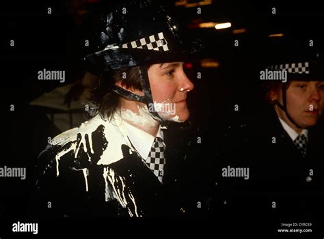 A Woman Police Officer Wpc Stands With White Paint Plashed Over Her Uniform During A Public