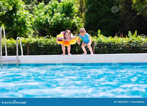 Kids Jumping Into Swimming Pool Stock Image Image Of Jump Aqua 74823253