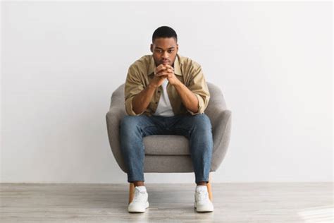 15900 Black Man Sitting Chair Stock Photos Pictures And Royalty Free