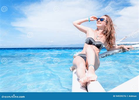 Young Caucasian Woman With Sunglasses Is Sitting On The Boat In