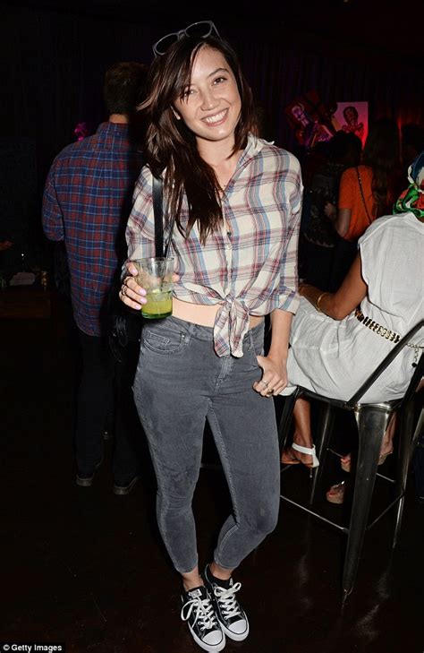 daisy lowe flashes her toned stomach as she steps out in a tied plaid shirt and black skinny