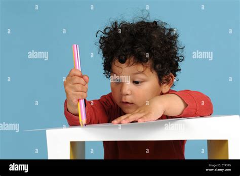 Little Boy Drawing With Pencils On Blue Background Stock Photo Alamy