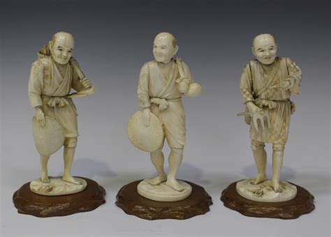 A Group Of Three Japanese Carved Ivory Okimono Figures Of A Fisherman