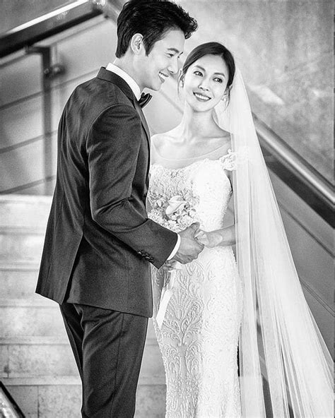 A Bride And Groom Standing On An Escalator