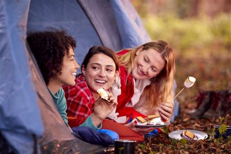 Group Of Female Friends On Camping Holiday In Forest Lying In Tent