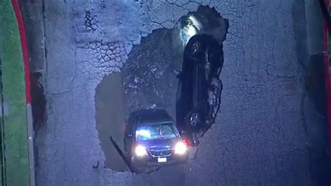 Video Captures Moment Sinkhole Swallows Two Cars In California
