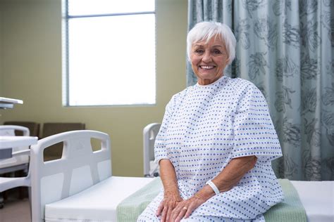 Smiling Senior Patient Sitting On Bed In Hospital Photo From Pikwizard