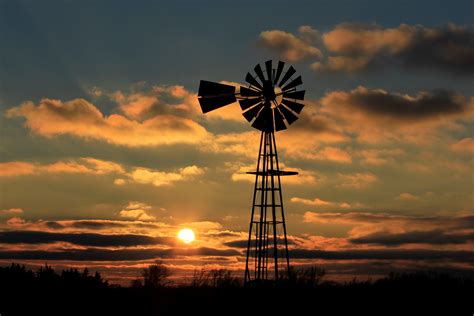 Kansas Colorful Sunset With Clouds And A Windmill Silhouette Out In The