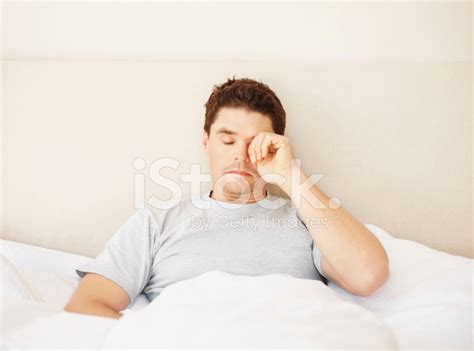 Man Rubbing His Eyes On Waking Up In Bed Stock Photo Royalty Free